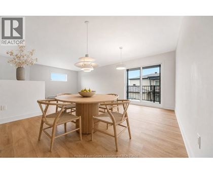 A dining room with a wooden table and chairs.