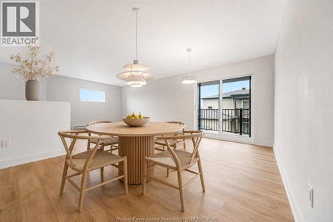 A dining room with a wooden table and chairs.