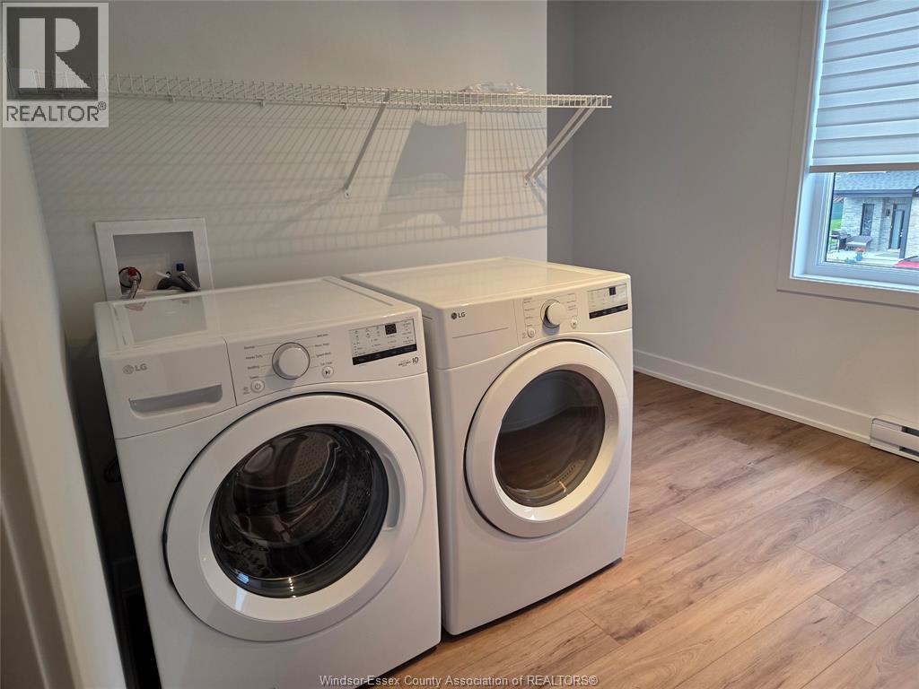 A white dryer and washer in a laundry room.