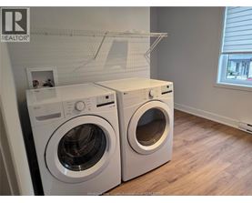 A white dryer and washer in a laundry room.