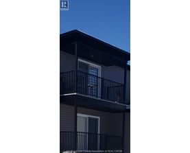 A balcony with a railing and a window on a building.