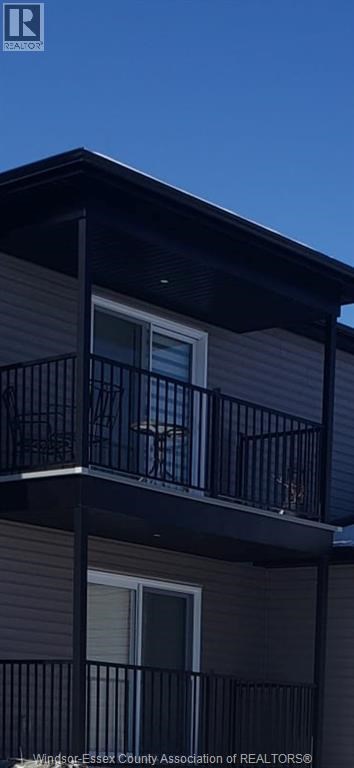 A balcony with a railing and a window on a building.