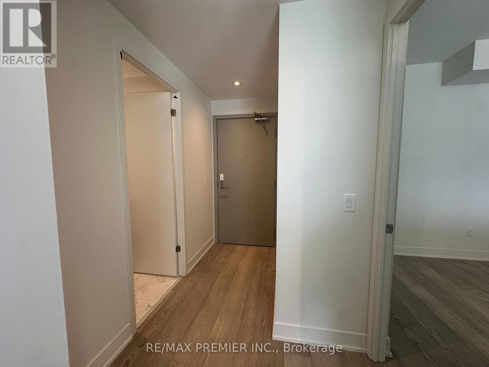 A hallway with a door on the right and a door on the left.