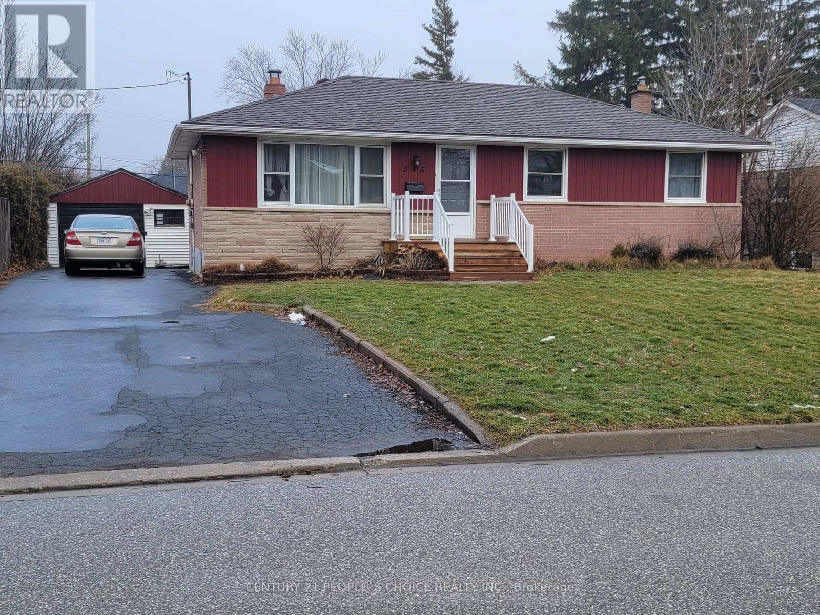 A red house with a white door and a car parked in front.