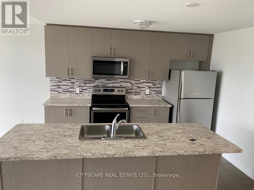 A kitchen with a sink, stove, and refrigerator.