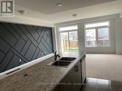 A kitchen with a sink and a window.