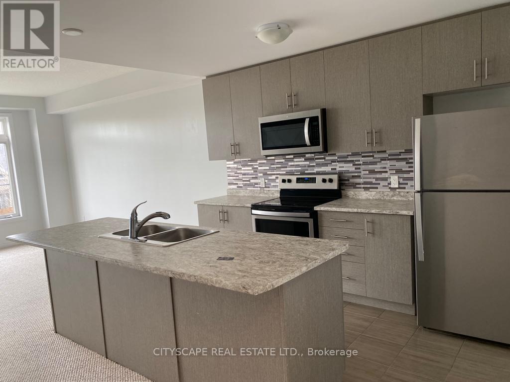 A kitchen with a granite countertop and stainless steel appliances.