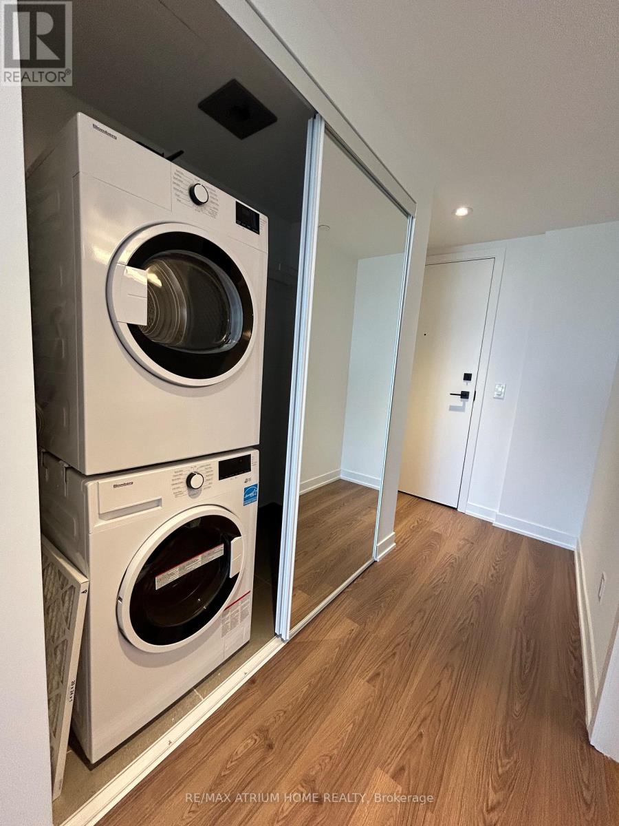 A white washer and dryer in a small room.