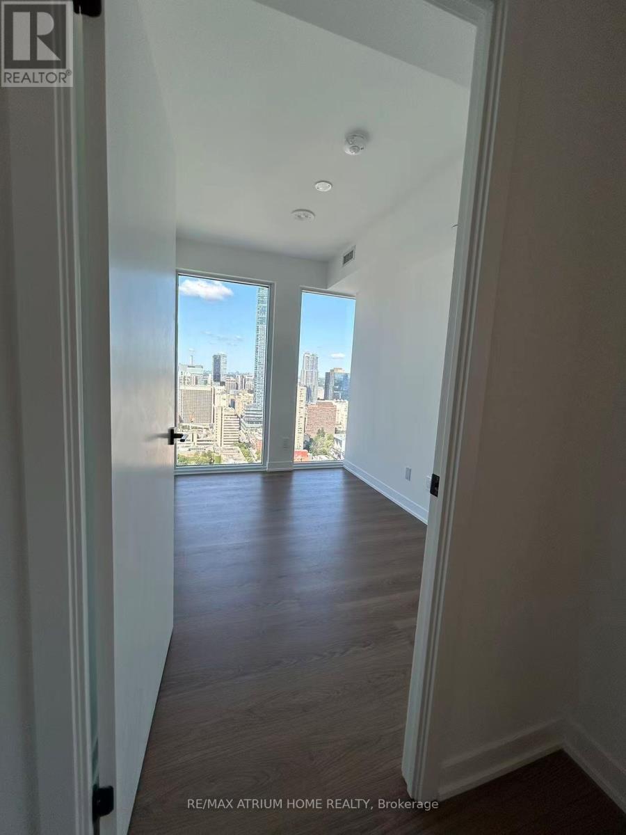 A hallway with a view of the city through the windows.