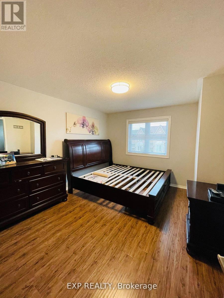 A bedroom with a bed, dresser, and mirror.