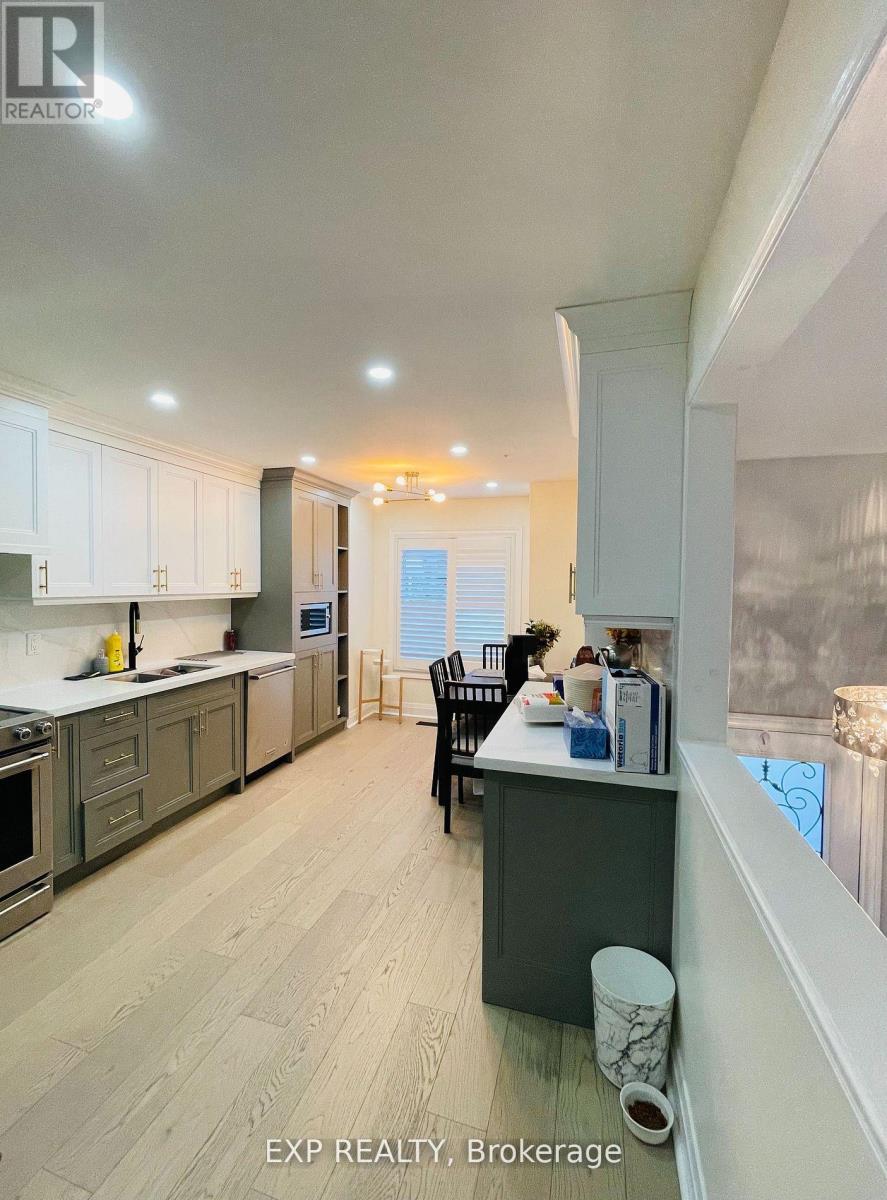 A kitchen with a dining table and chairs.