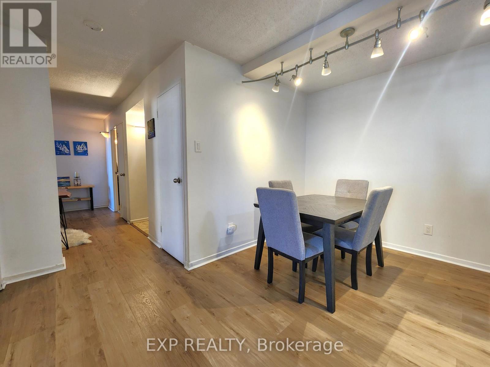 A dining room with a table and chairs.