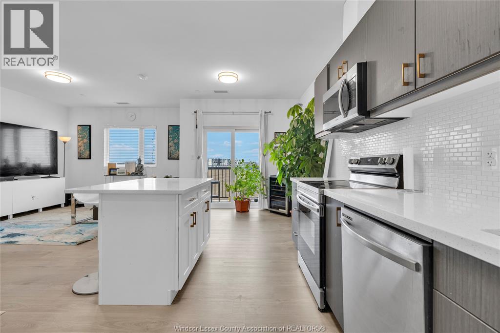A modern kitchen with white cabinets and stainless steel appliances.