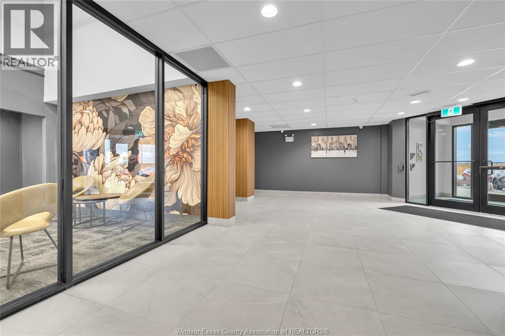 A modern office space with a glass wall and a wooden door.