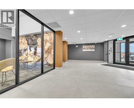 A modern office space with a glass wall and a wooden door.