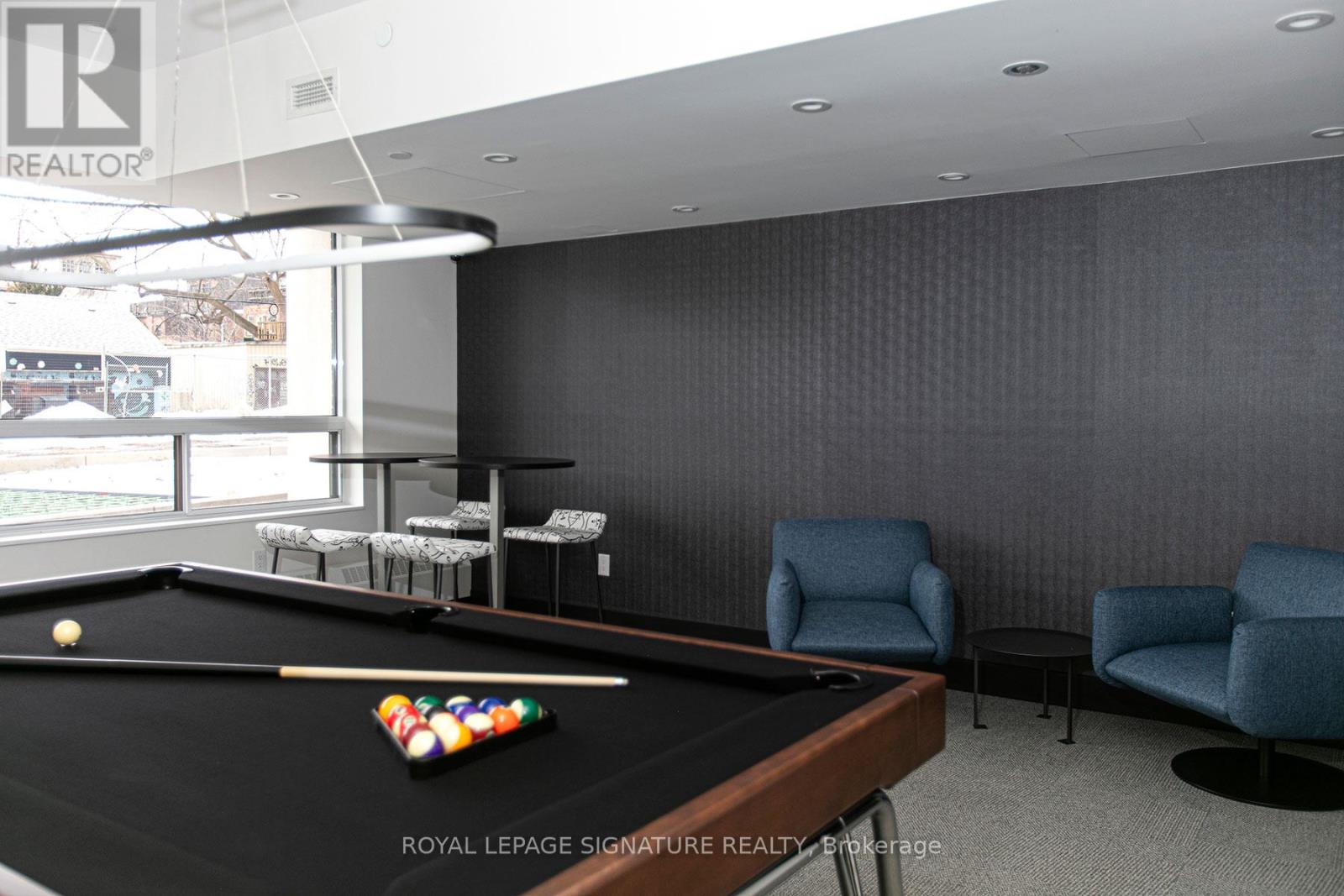 A pool table with a royal lepage signature realty logo on it.