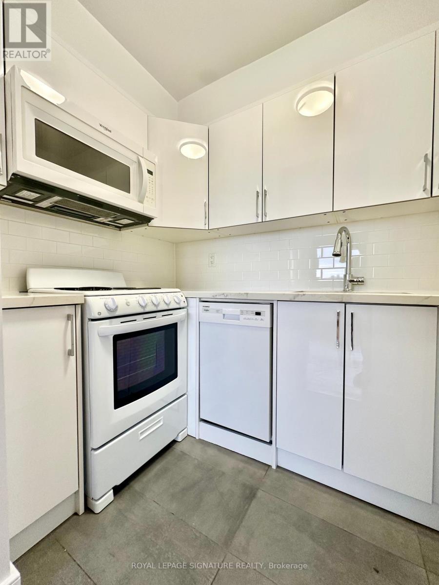 A white kitchen with a microwave above the stove.