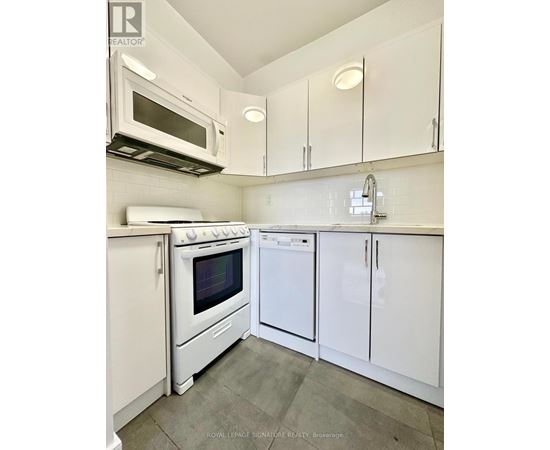 A white kitchen with a microwave above the stove.