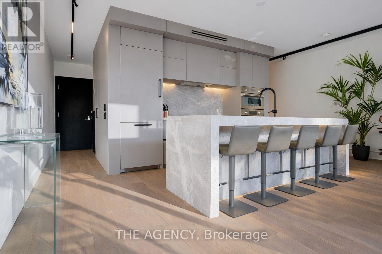 A modern kitchen with a bar area and seating.