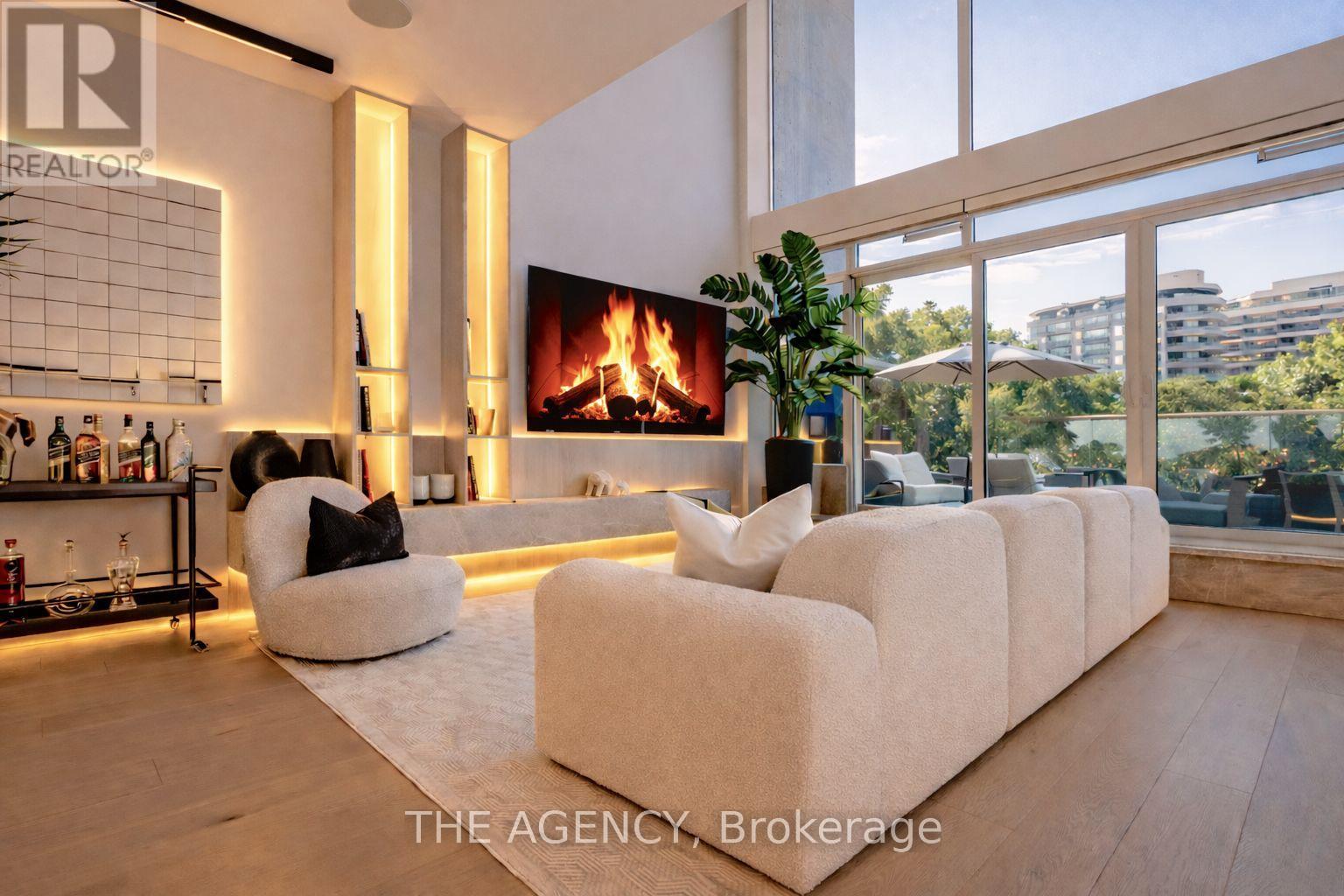 A modern living room with a fireplace and a large couch.