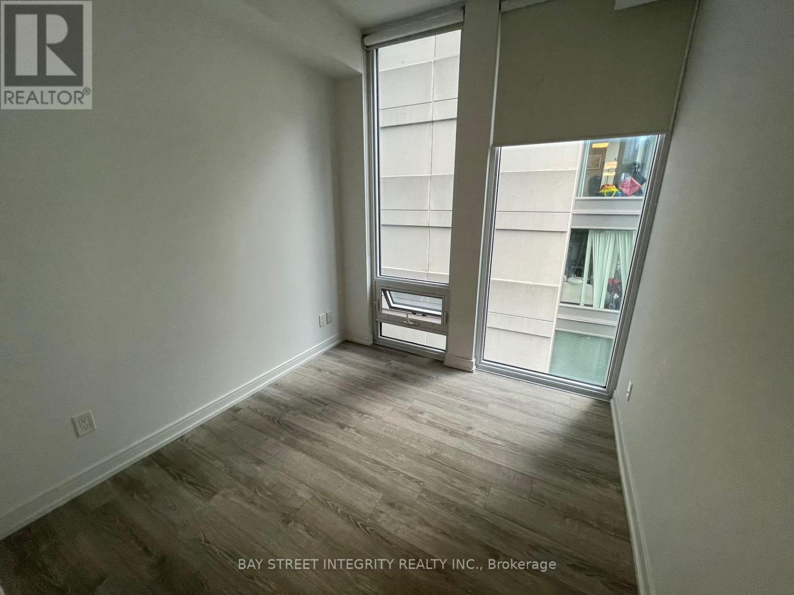 A room with a sliding glass door leading to a balcony.