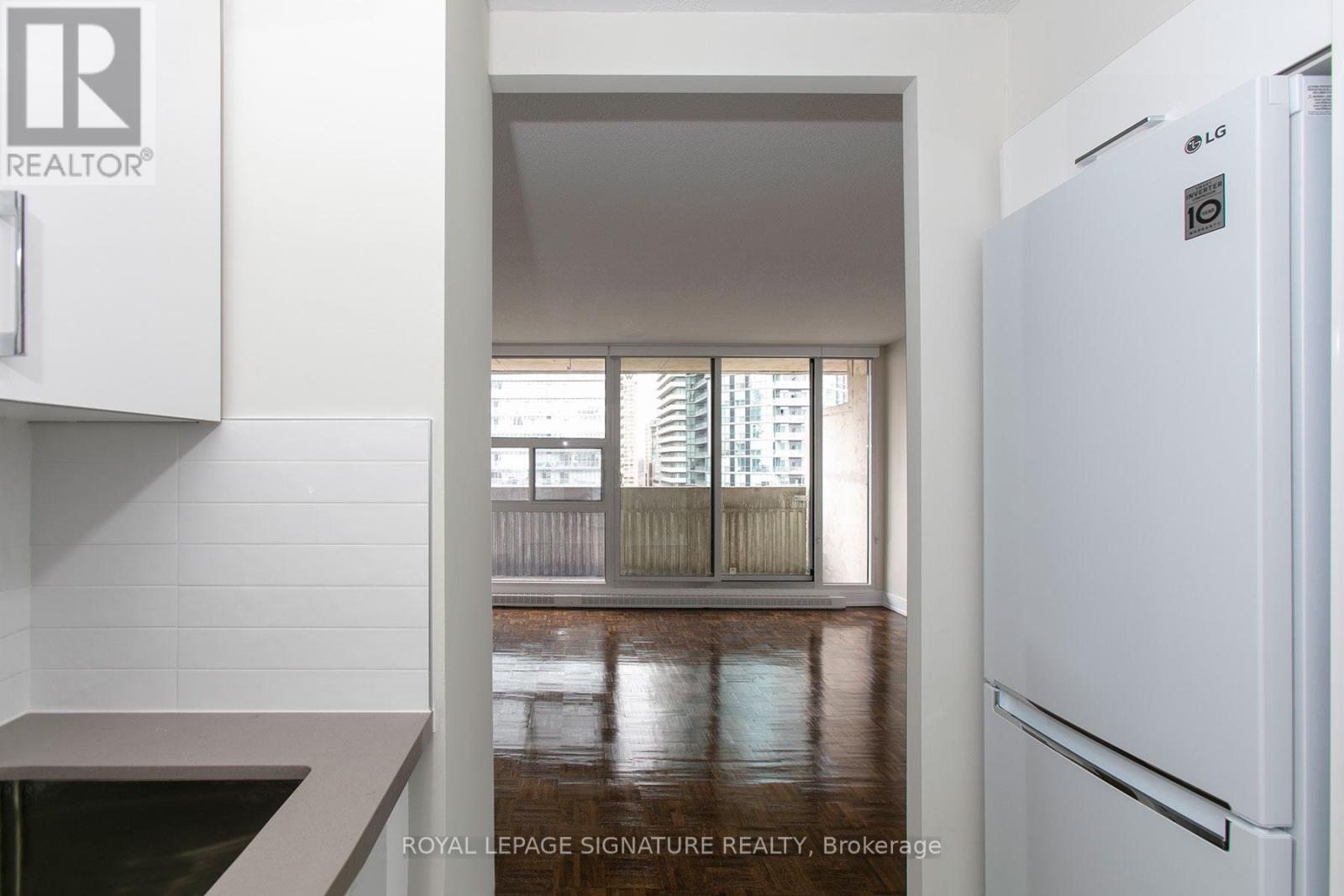 A kitchen with a refrigerator and a counter top.