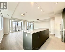 A spacious kitchen with dark cabinets and a large island.