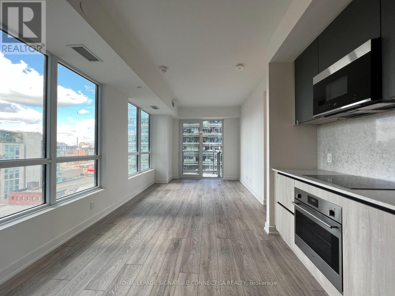A spacious kitchen with a stove top oven and microwave.