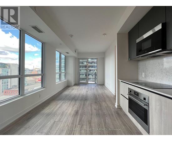 A spacious kitchen with a stove top oven and microwave.