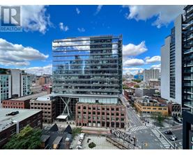 A modern glass building stands out in the cityscape.