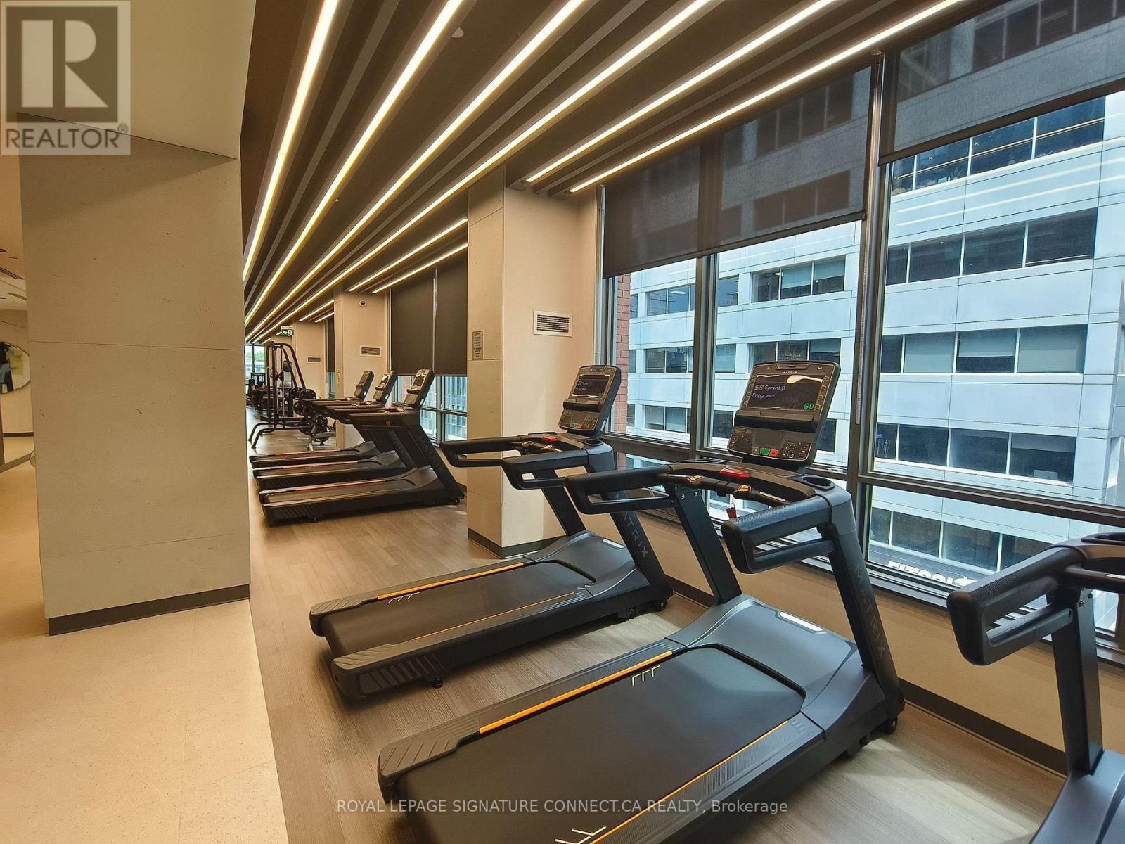 A gym with treadmills and a logo that says REALTOR.