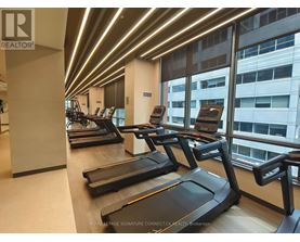 A gym with treadmills and a logo that says REALTOR.