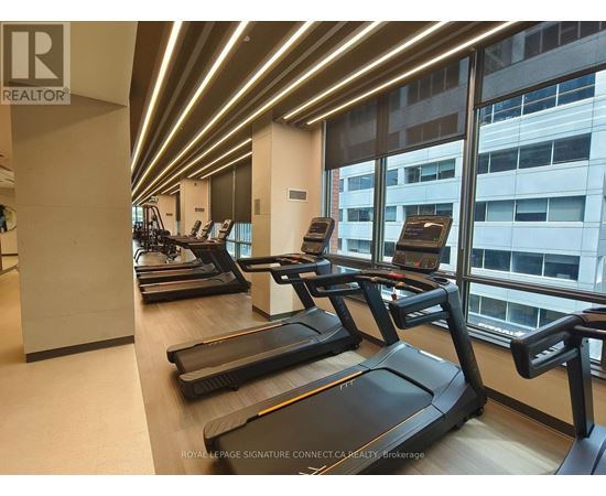 A gym with treadmills and a logo that says REALTOR.
