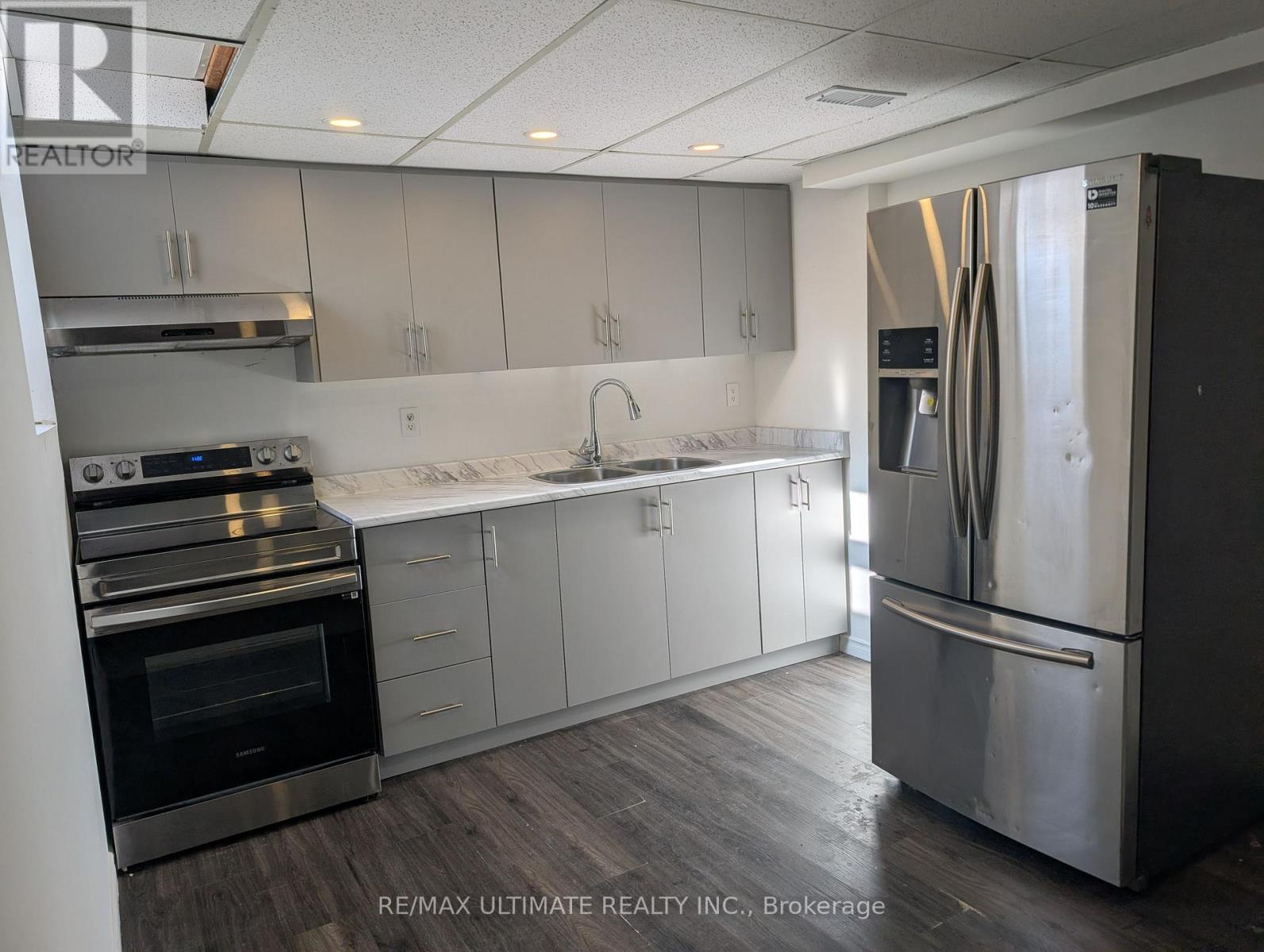 A modern kitchen with stainless steel appliances and white cabinets.