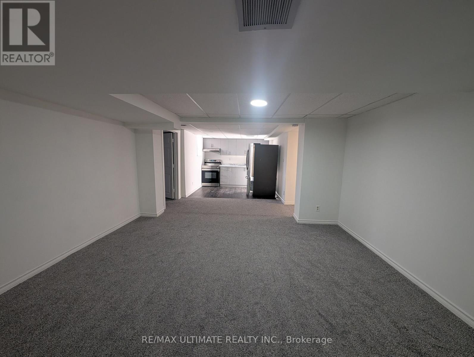 A brokerage office with a carpeted floor and white walls.