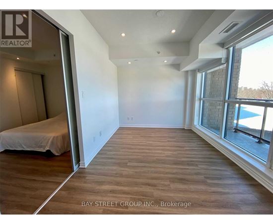 A bedroom with a bed and a window overlooking a pool.