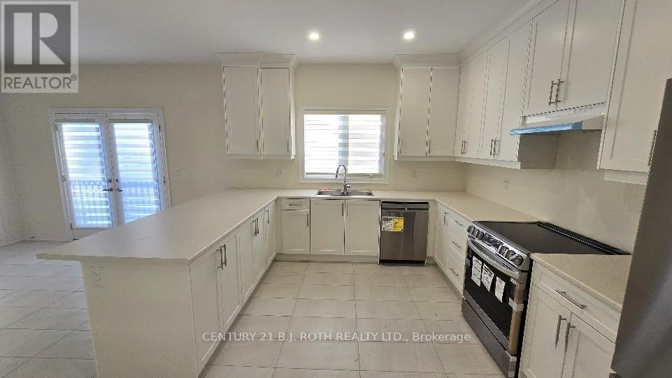 A kitchen with white cabinets and a black oven.