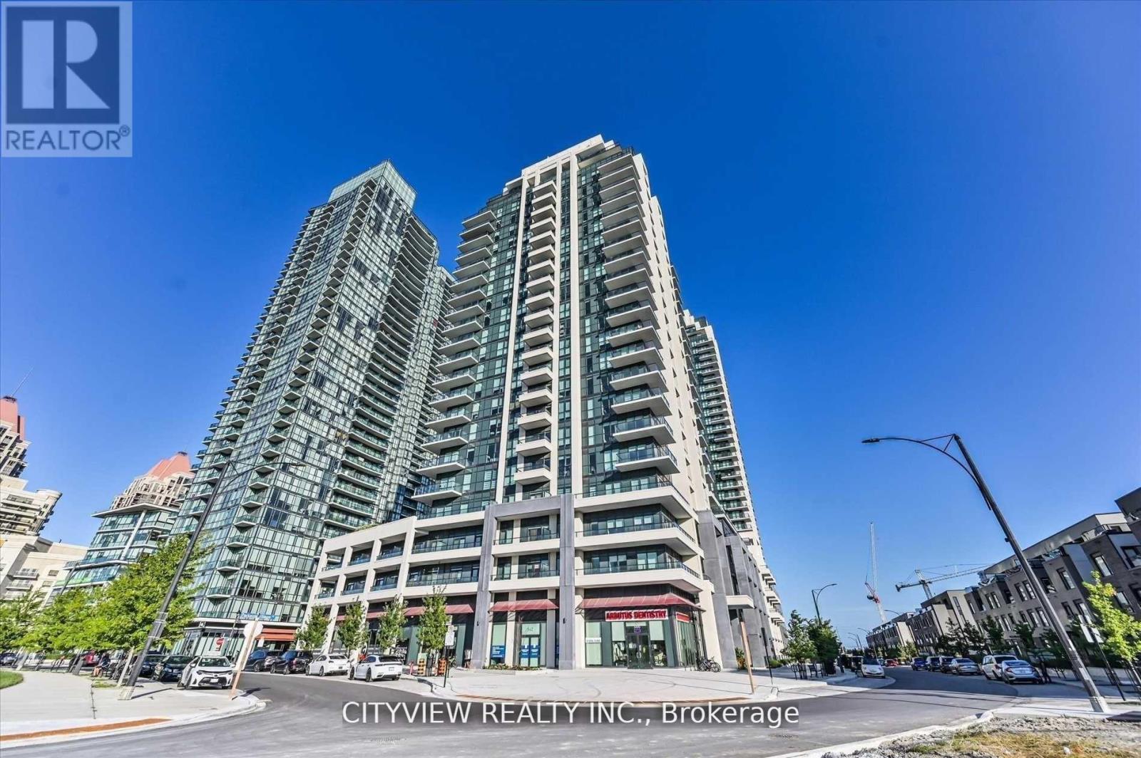 A tall building with many windows is the main focus of the image.