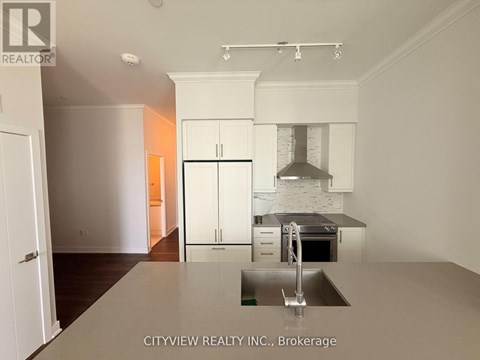A kitchen with a sink and cabinets.