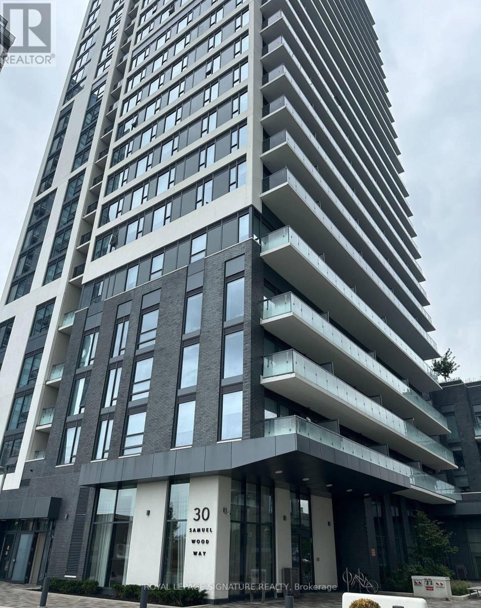 A tall residential building with balconies and a sign that reads 30.
