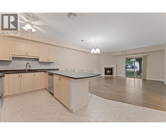 A kitchen with wooden cabinets and a black countertop.