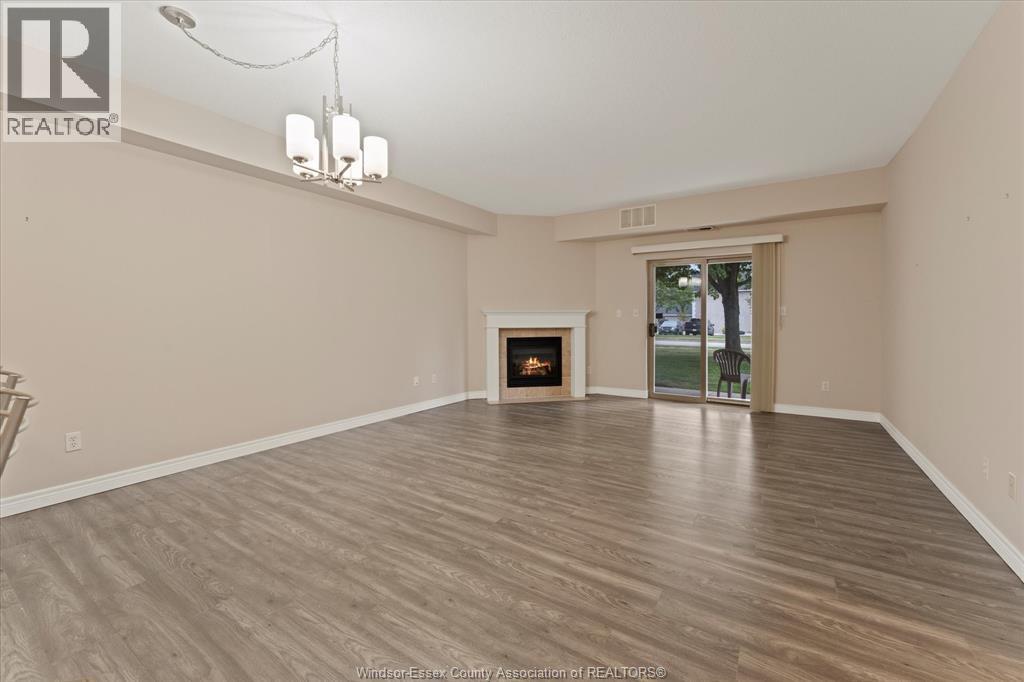 A spacious living room with a fireplace and sliding glass doors.