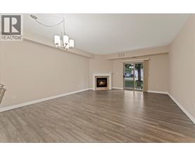 A spacious living room with a fireplace and sliding glass doors.