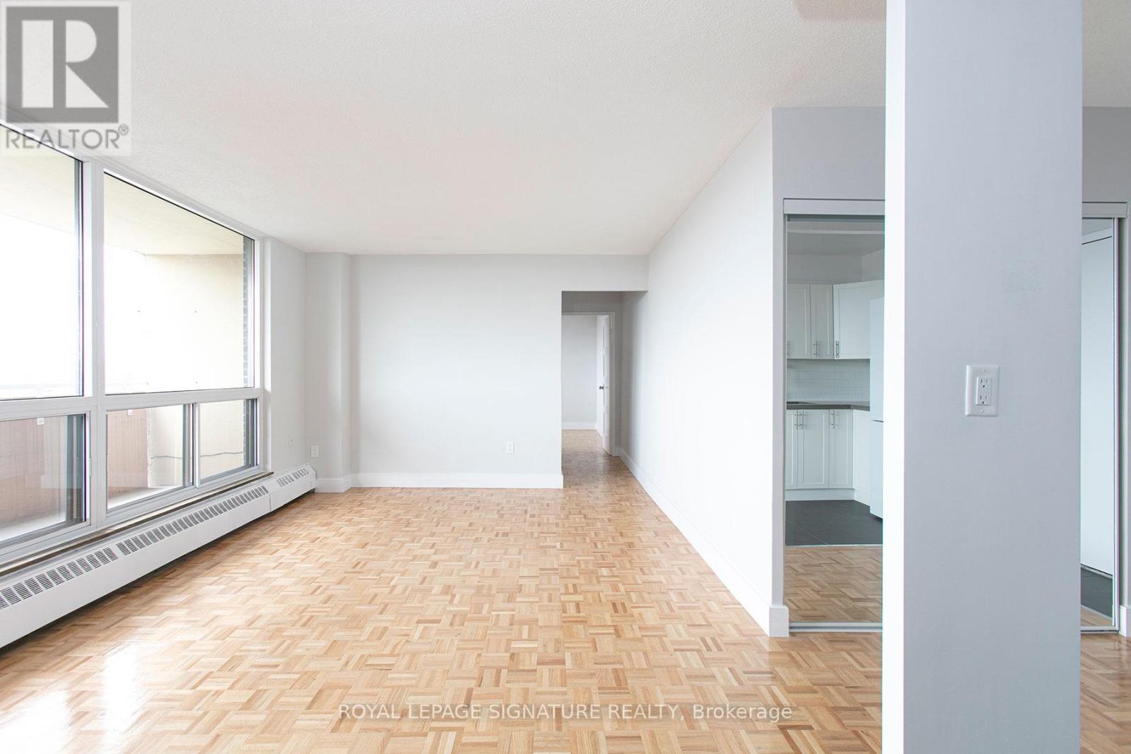 A room with a wooden floor and white walls.