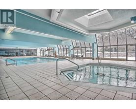 A large indoor pool with a slide and a skylight.