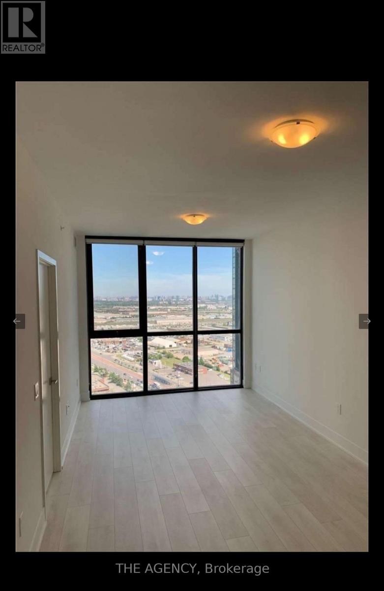 A room with a view of the city from a large window.