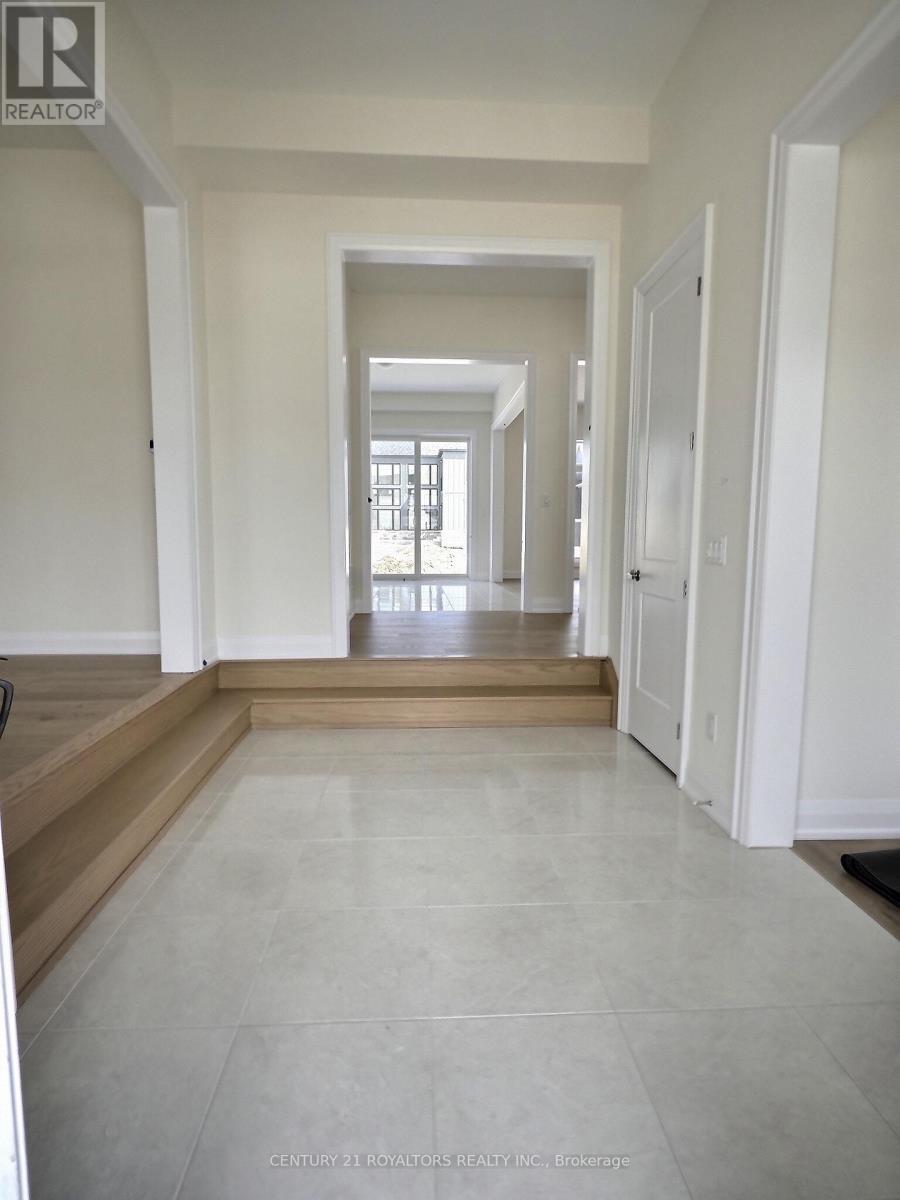 A long hallway with white walls and tile flooring.