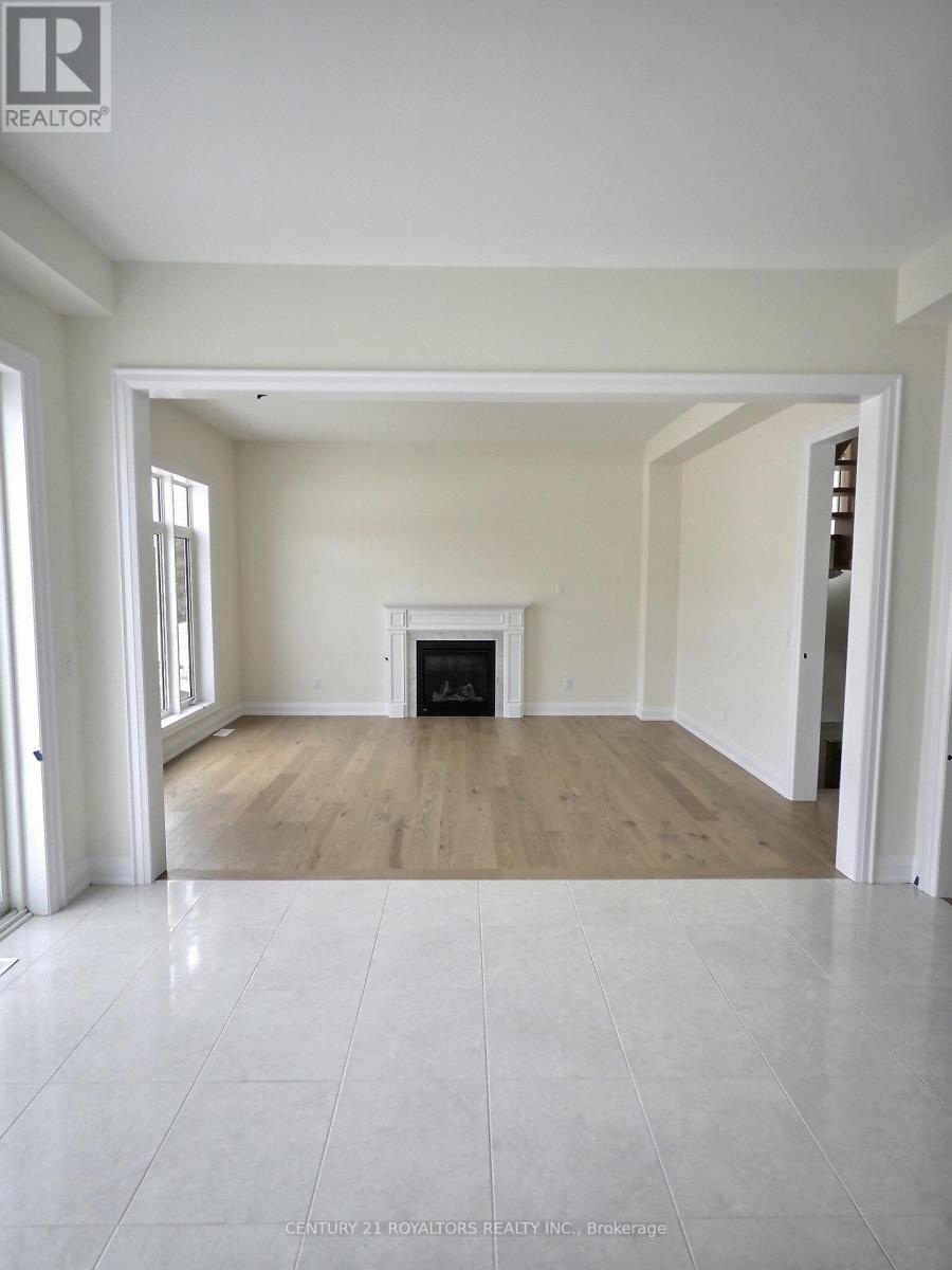 A spacious living room with a fireplace and hardwood floors.
