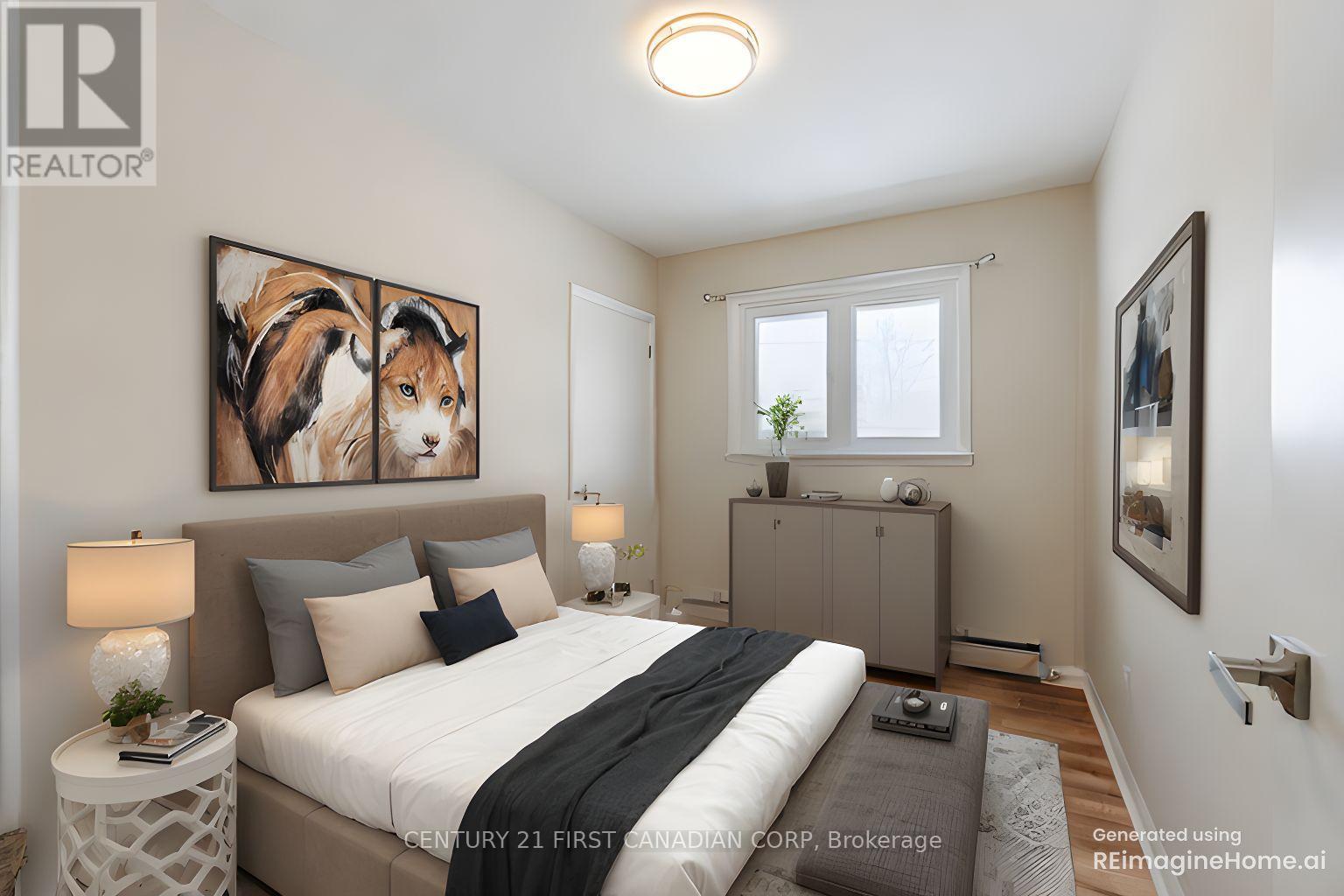 A bedroom with a large bed and a painting of a dog on the wall.