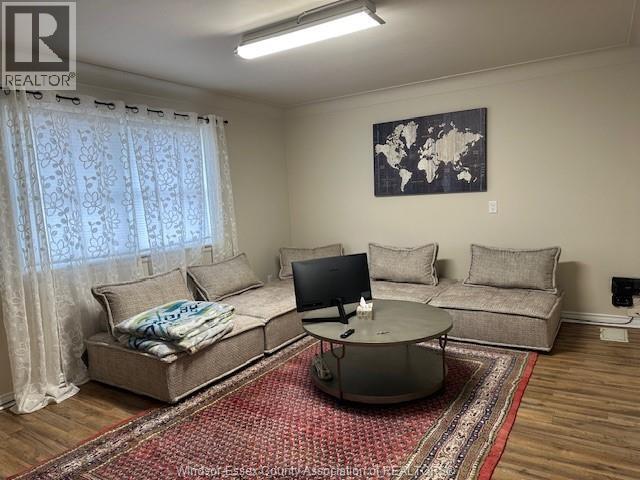 A living room with a couch, a coffee table, and a television.